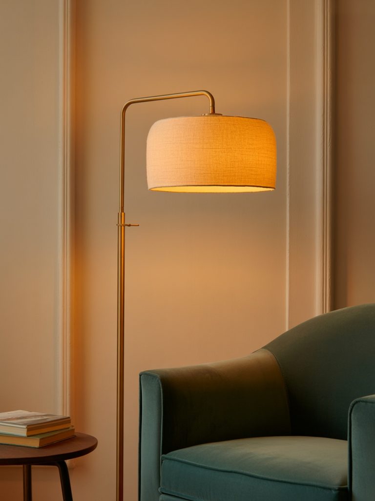 A stylish floor lamp illuminating a cozy reading nook with an open book on a small table.